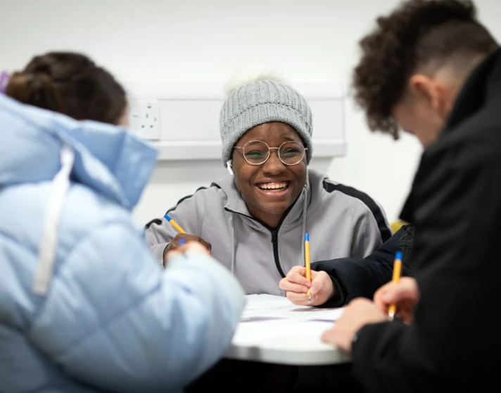 Students smiling and working together at a table in the East End campus common room at Glasgow Kelvin College. Students smiling and working together at a table in the East End campus common room at Glasgow Kelvin College.